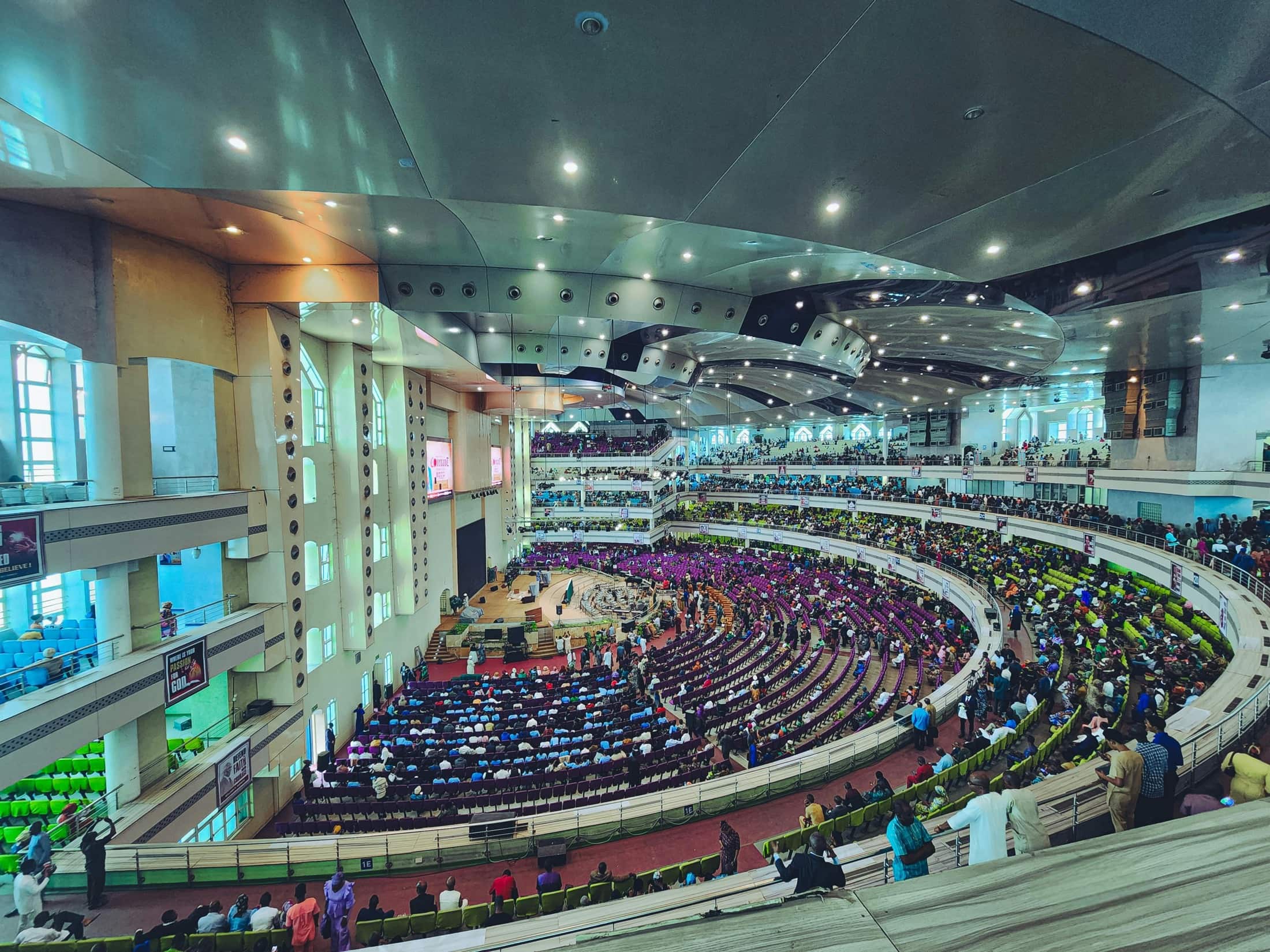 Attendees filling a large event hall during a live business gathering