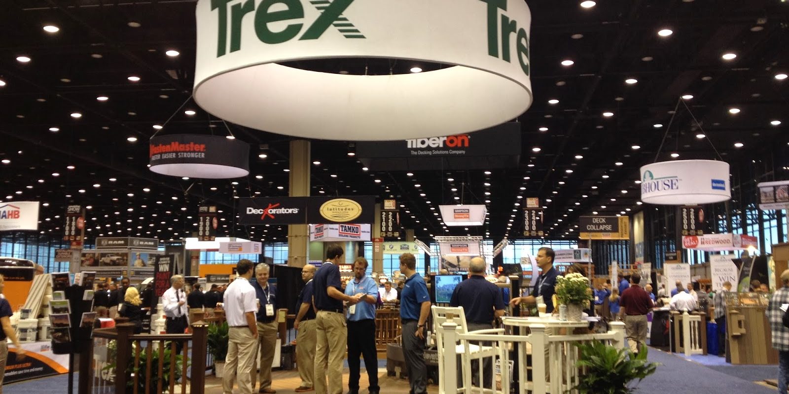 Attendees moving across a busy trade show floor