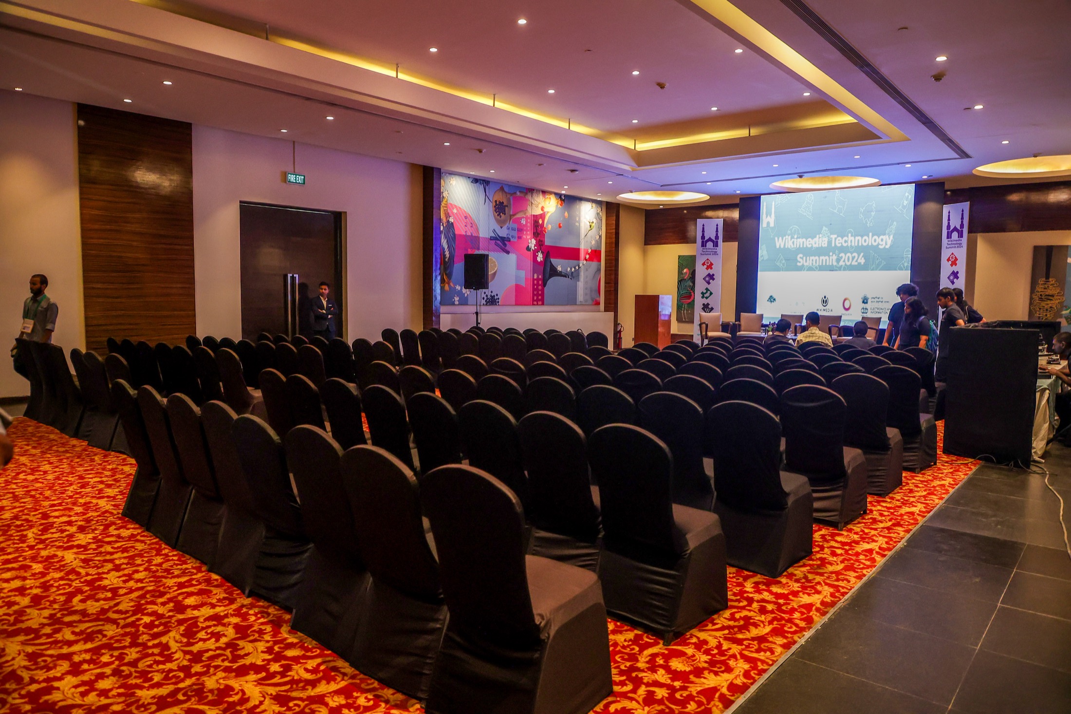 Conference attendees seated in a large event hall during a business session