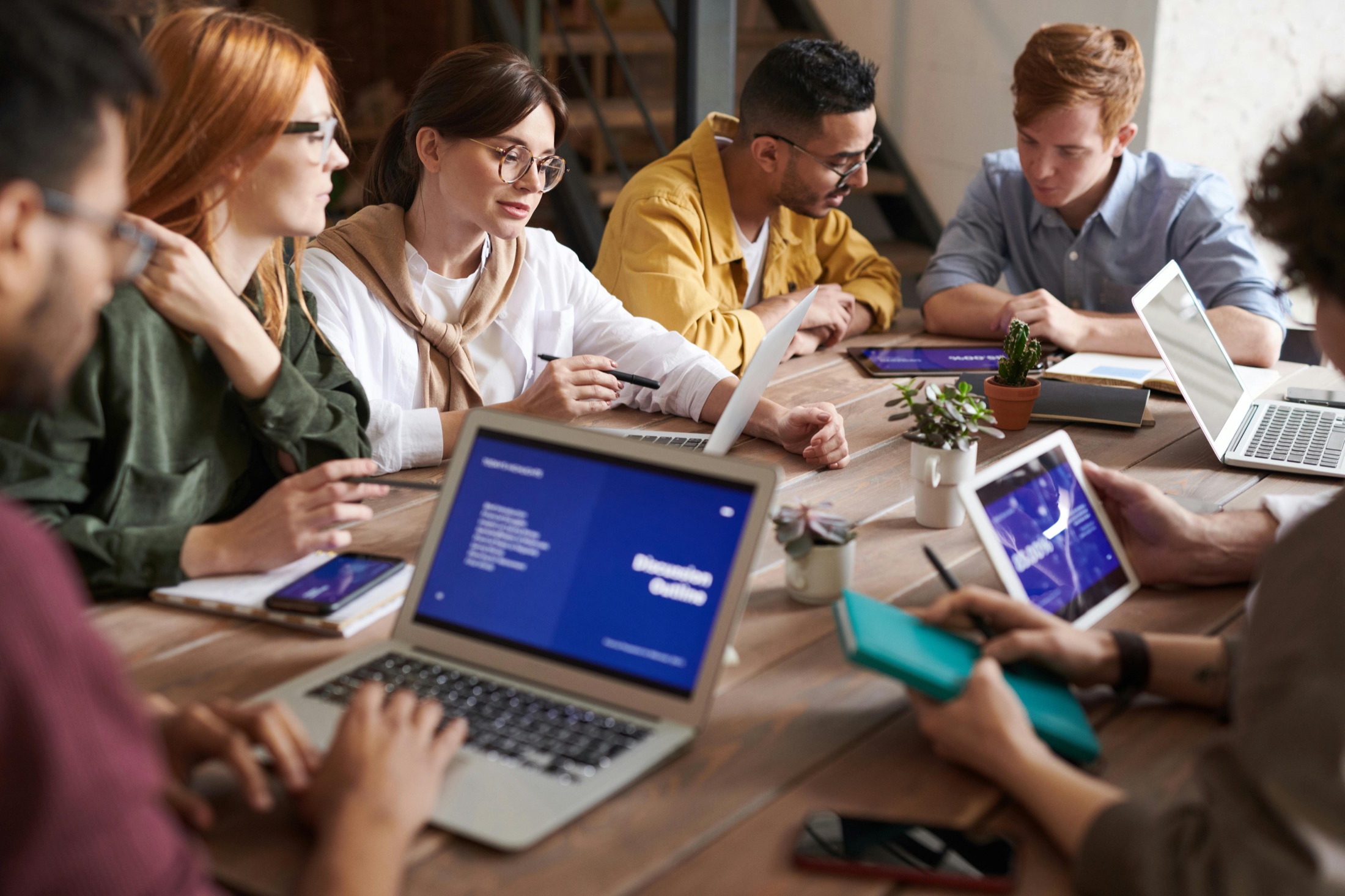 Business team gathered around a table in a working session before an event